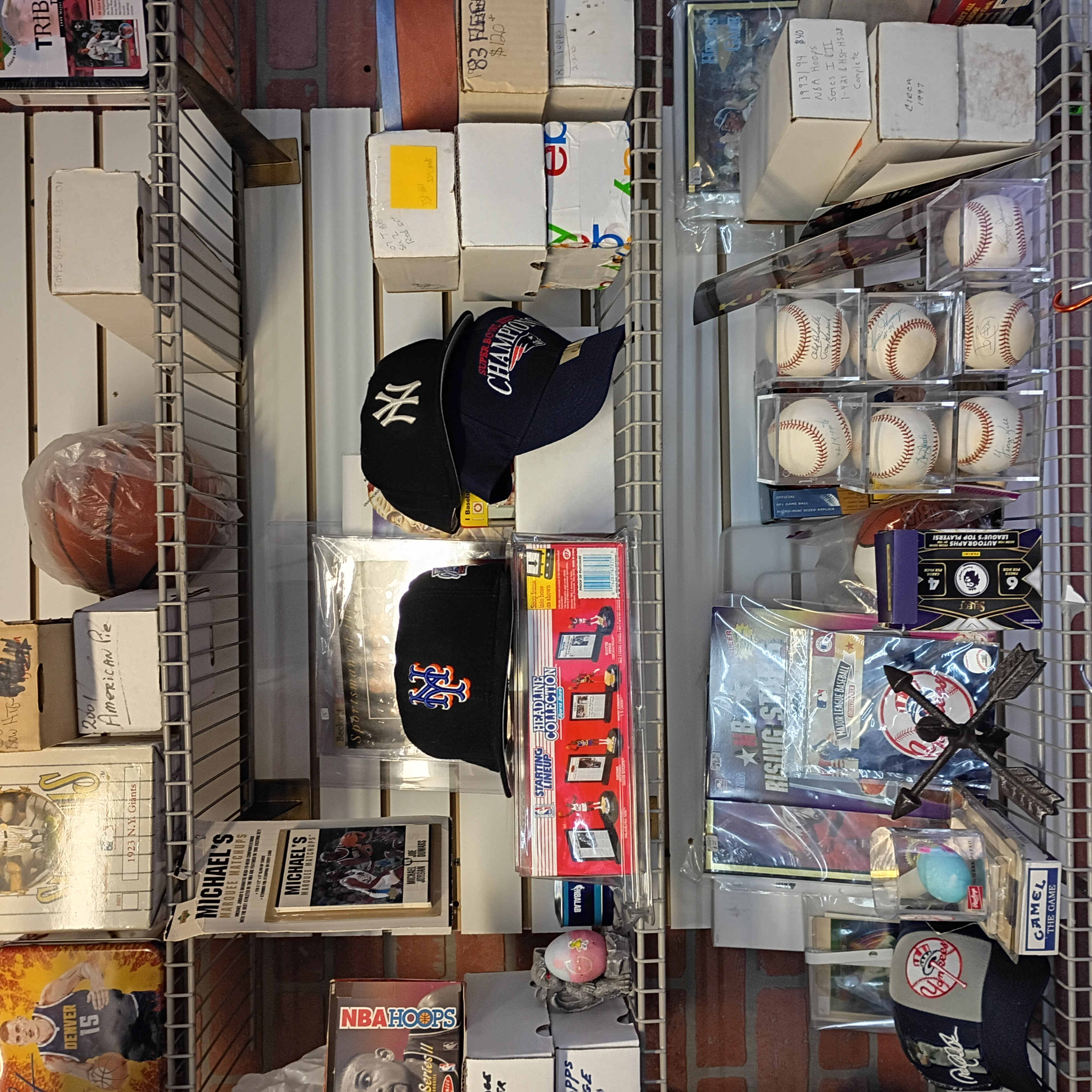 Overhead view of card boxes, hats, baseballs, and memorabilia shelves at Finn McCool's.