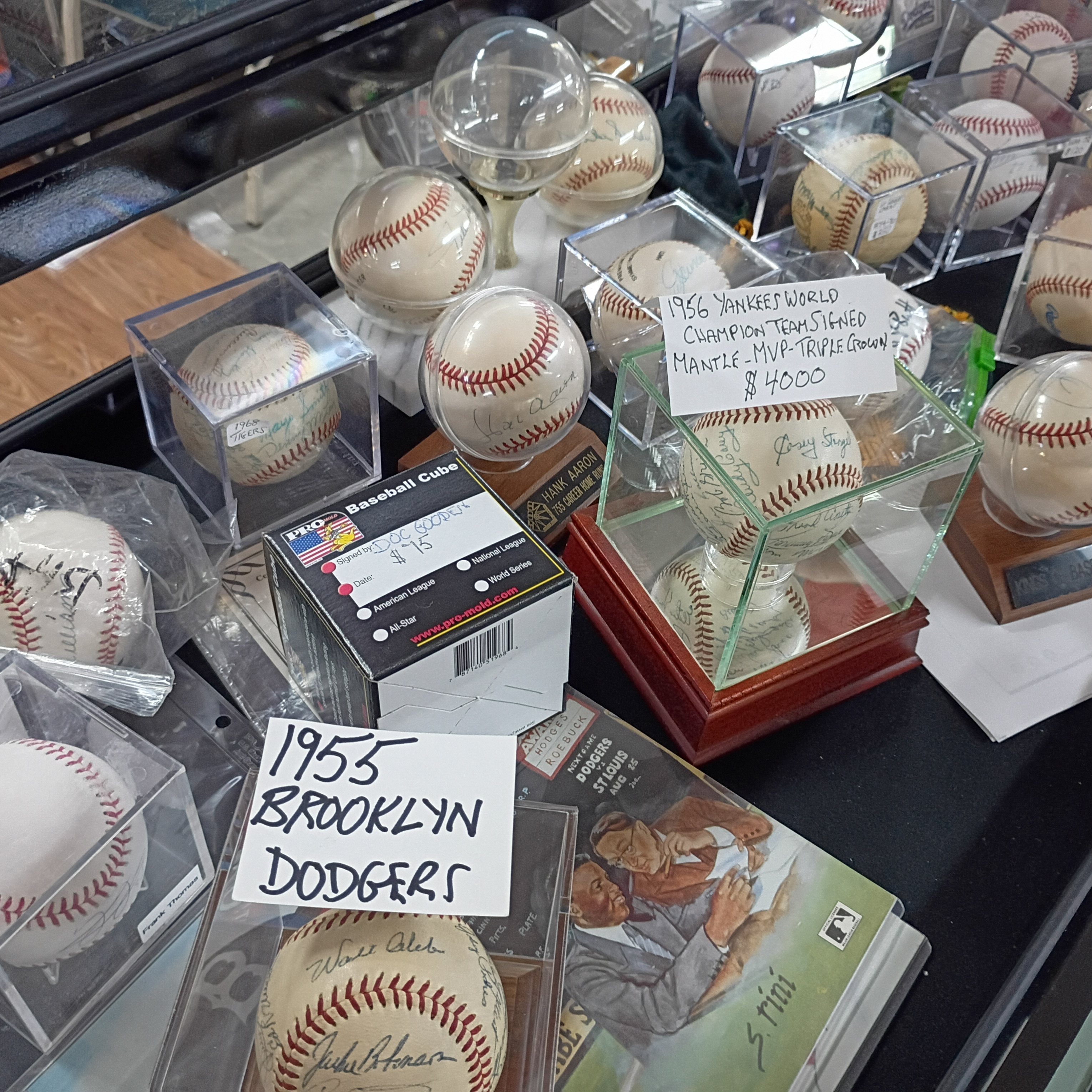 Close-up of vintage team-signed baseballs in a display case at Finn McCool's.