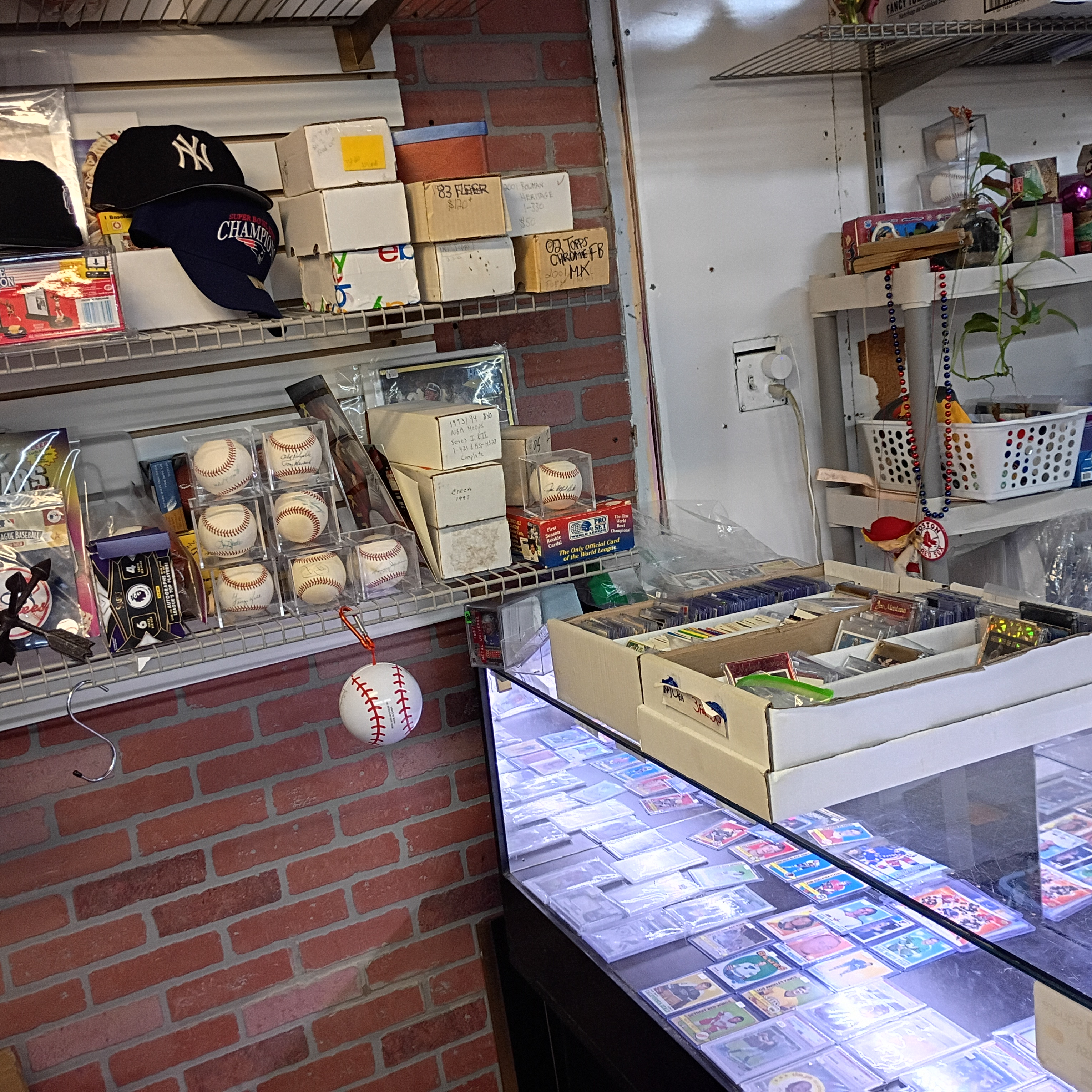 Store corner with brick wall, display case, and baseballs on shelf at Finn McCool's.
