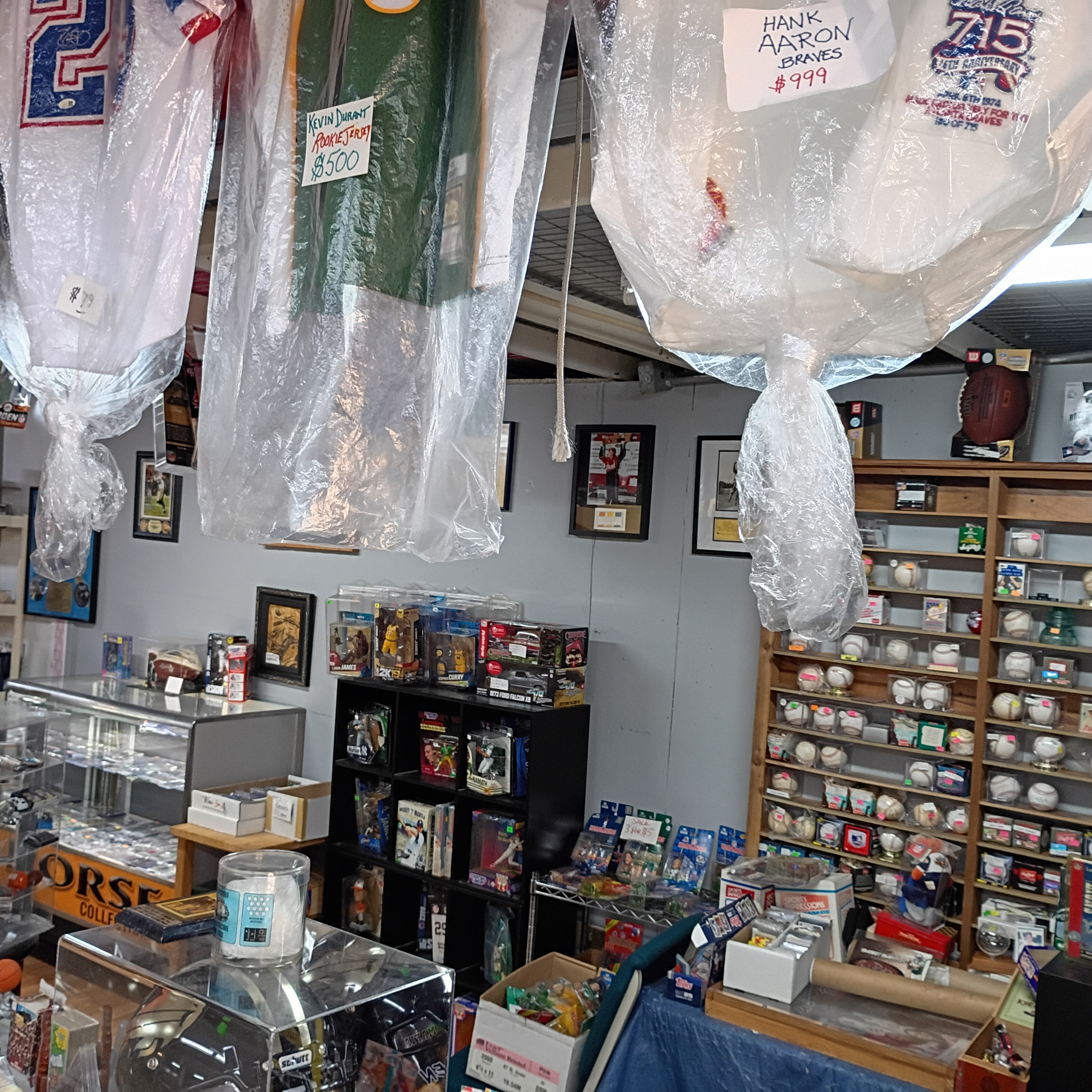 Sports collectibles and card displays inside Finn McCool's store at the Daytona Flea Market.